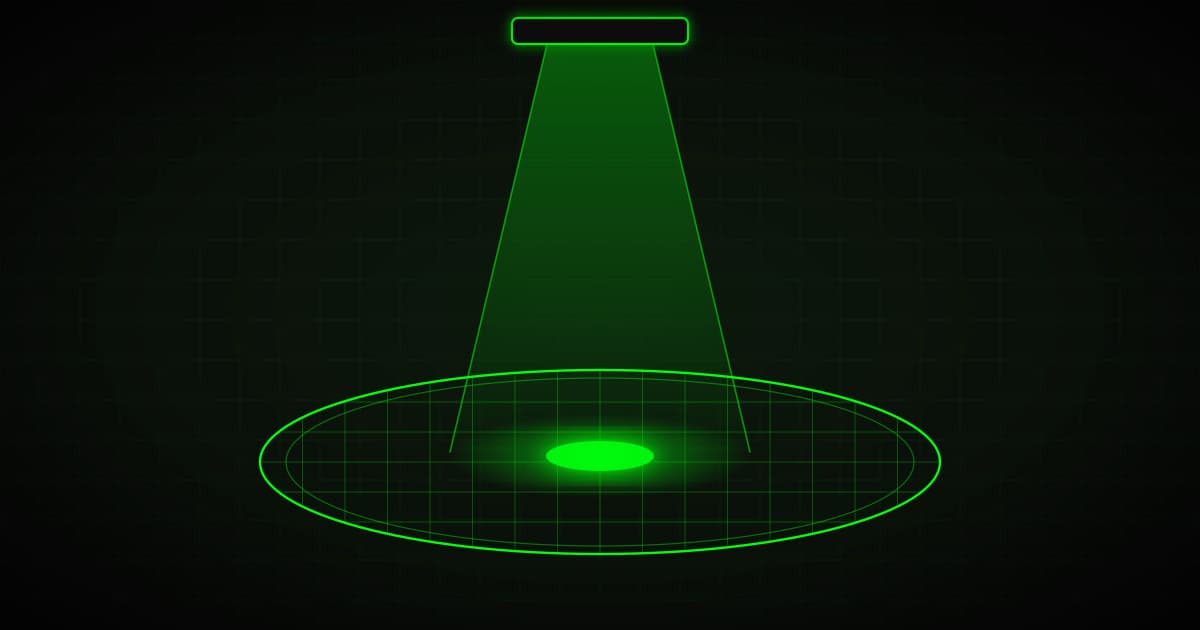 Silicon wafer with ultra-fine circuits under a focused beam of light, green on black